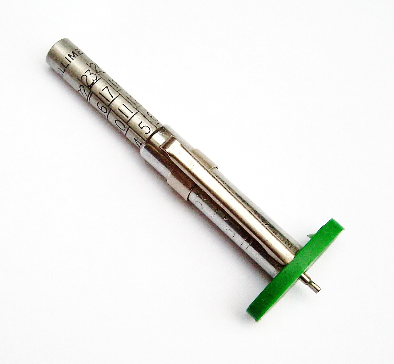A tire tread depth gauge measuring remaining tread -- the precise version of the penny test